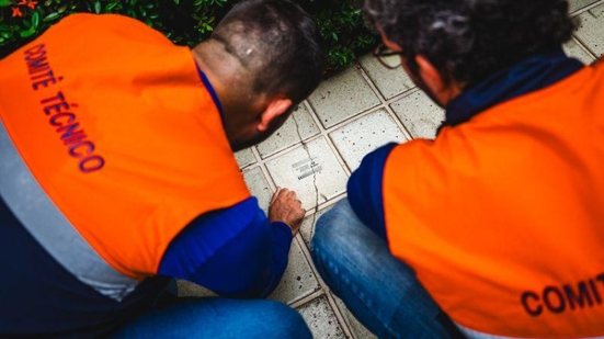 Técnicos conversam com moradores durante vistoria em imóvel próximo à área monitorada em Maceió