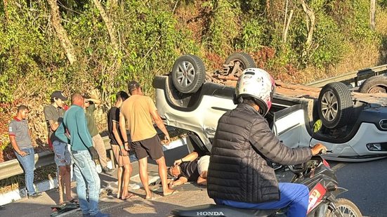 Carro branco capotado na BR-316 enquanto motoristas auxiliam no atendimento à vítima.
