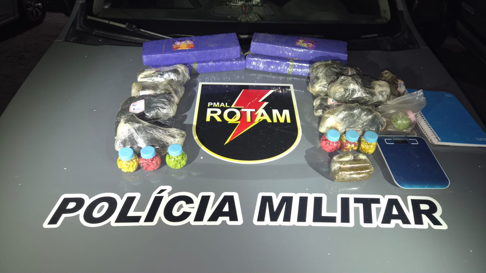 Drogas apreendidas pela Rotam sobre uma viatura da Polícia Militar em Maceió